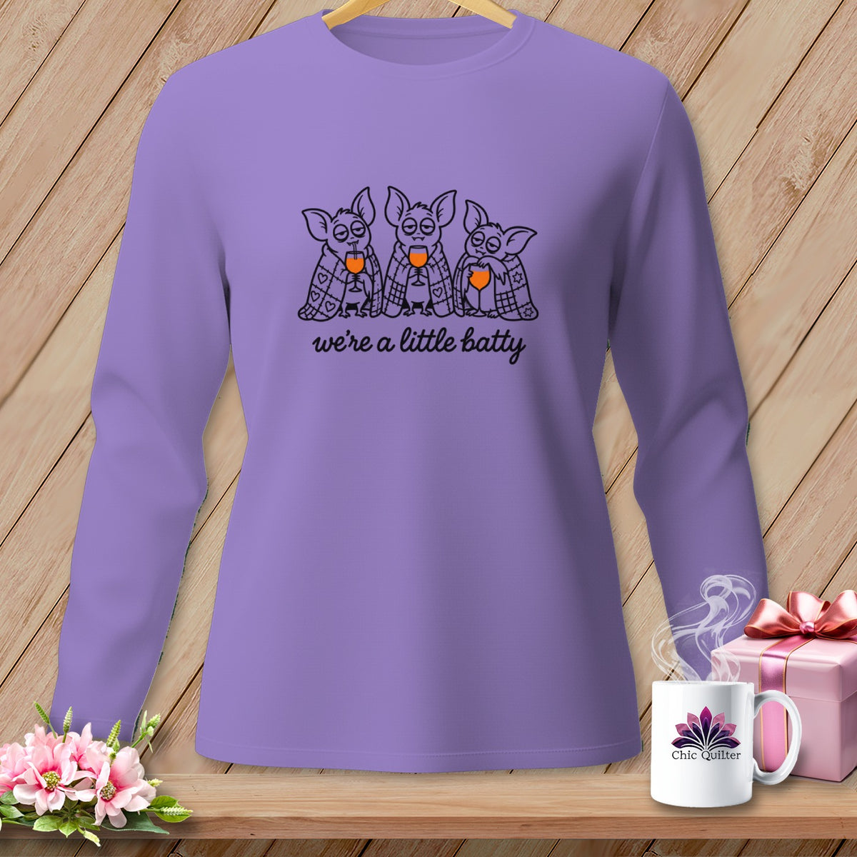 Purple long-sleeved shirt with bats drinking and "we're a little batty" text.