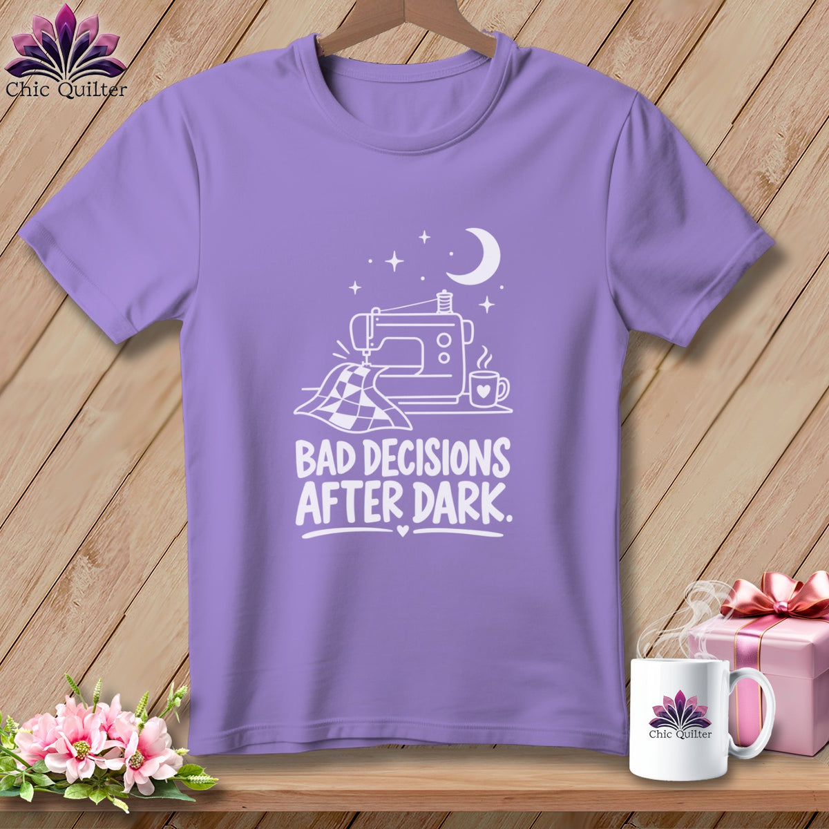 Lavender t-shirt with a white graphic of a sewing machine and the text "Bad Decisions After Dark".