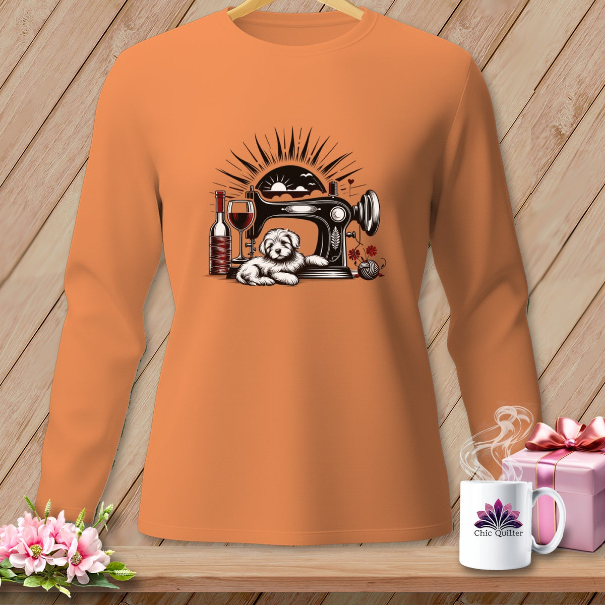 Orange long-sleeve shirt with sewing machine, dog, wine, and yarn graphic.