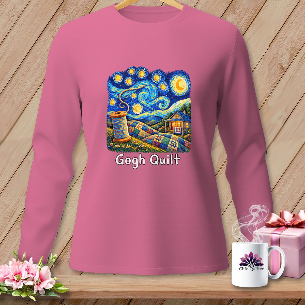 Pink long-sleeve shirt with a "Gogh Quilt" design featuring a starry night scene and a spool of thread.