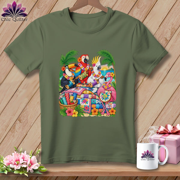 Olive green t-shirt featuring a graphic of tropical birds playing instruments around a colorful quilt.