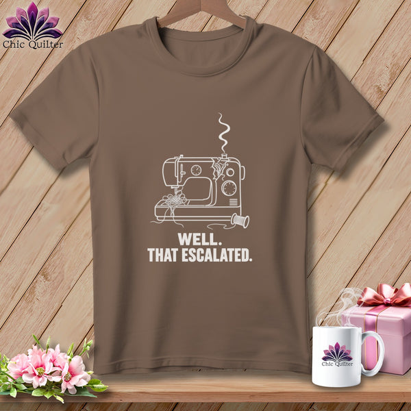 Brown t-shirt with white outline of a broken sewing machine and text "WELL. THAT ESCALATED."