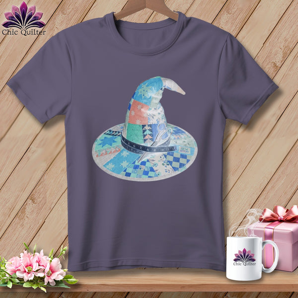 Purple t-shirt with patchwork witch hat graphic featuring scissors and tape measure.