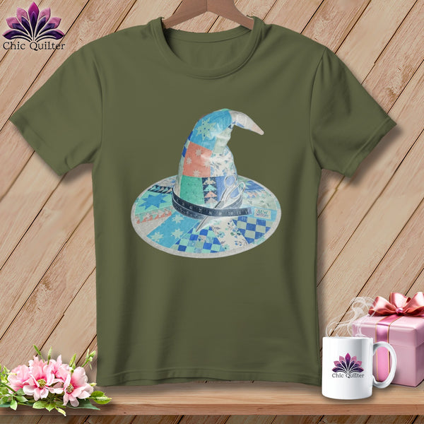 Green t-shirt with a patchwork witch hat featuring a tape measure and scissors.