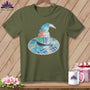 Green t-shirt with a patchwork witch hat featuring a tape measure and scissors.