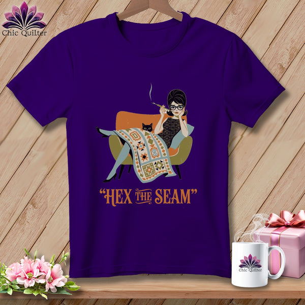 Purple t-shirt with graphic of woman and cat, reading "HEX the SEAM".