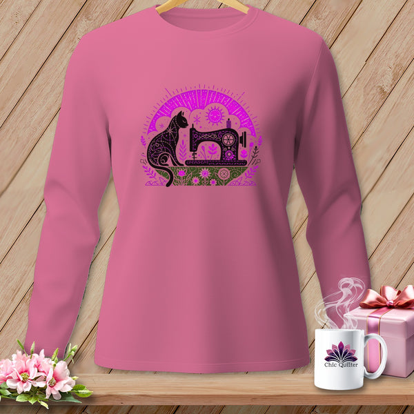 Pink long-sleeved shirt with a black cat and sewing machine graphic.
