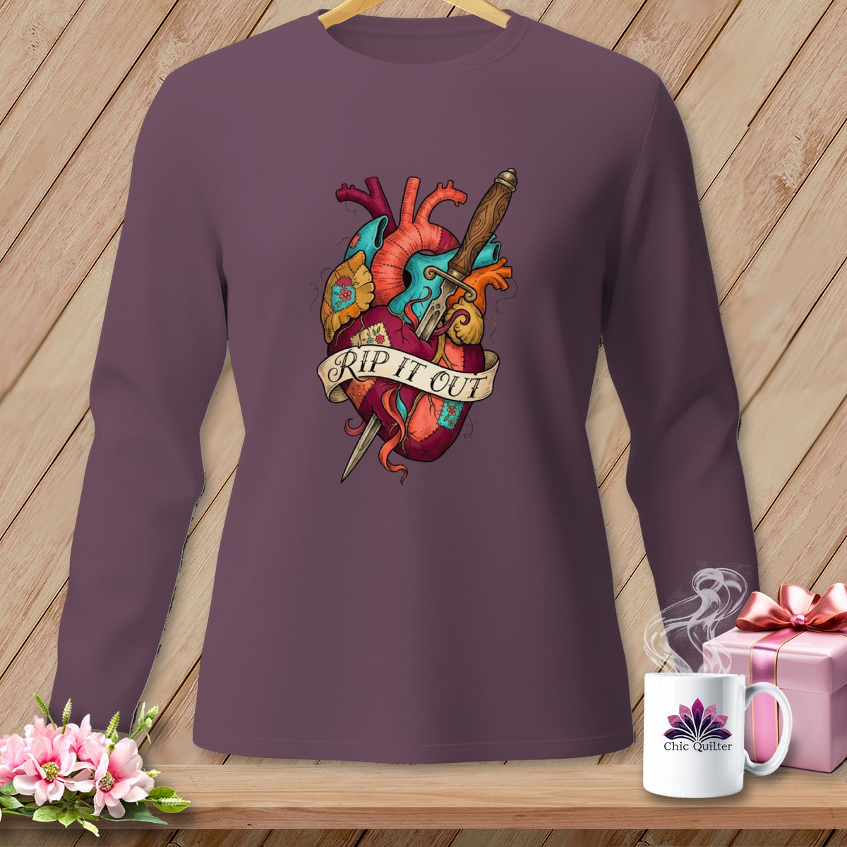 Purple long-sleeve shirt with anatomical heart graphic and dagger, text reads "RIP IT OUT".