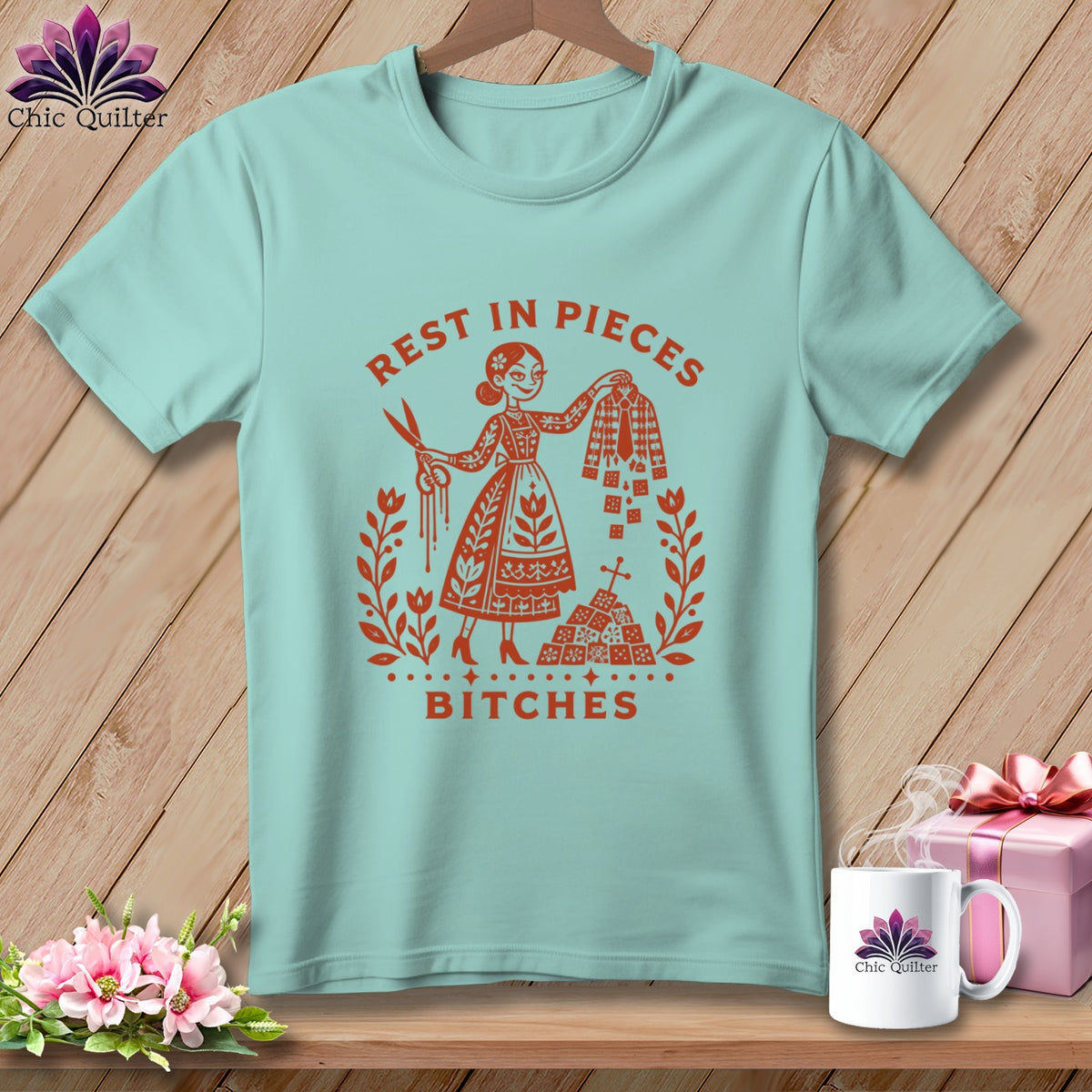 Light blue t-shirt with "Rest in Pieces Bitches" graphic and floral wreath.
