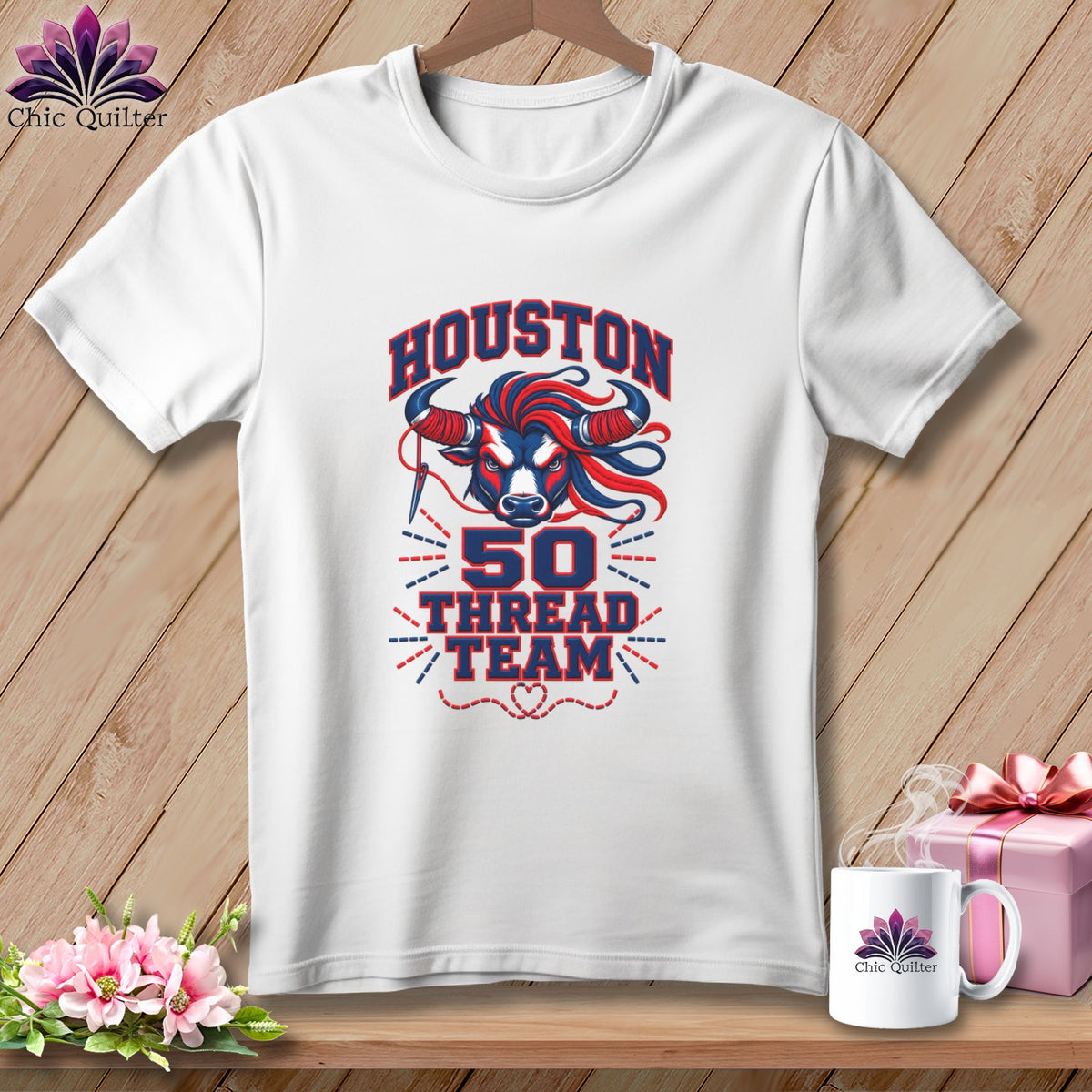 White t-shirt hanging on a wooden background, featuring a Houston 50 Thread Team bull graphic.