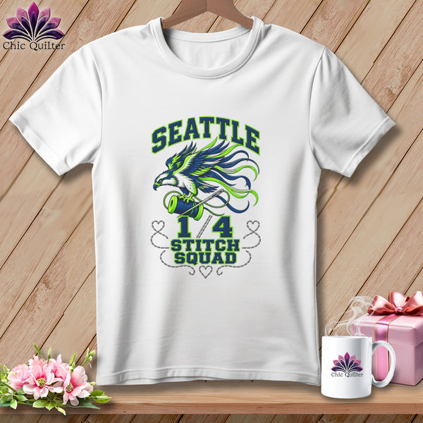 A white crewneck t-shirt featuring a blue and green seattle hawk graphic and text reading "1/4 Stitch Squad".