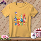Gold t-shirt featuring four colorful cartoon birds wearing scarves while perched on a knitting needle.
