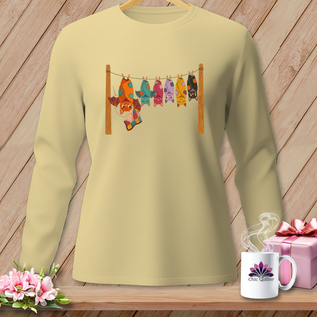 Light yellow shirt with colorful patchwork bats hanging from a clothesline.