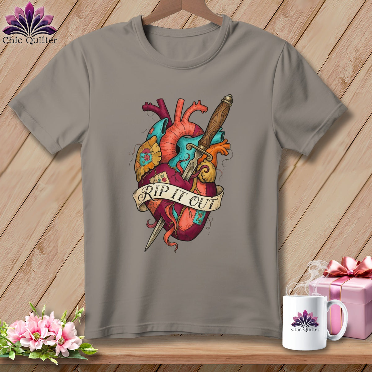 Grey t-shirt with anatomical heart, dagger, and "RIP IT OUT" banner design.