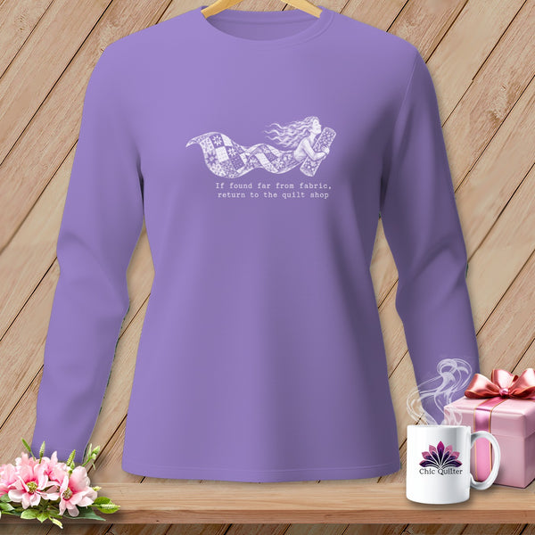 Purple long-sleeve shirt with a white graphic of a woman holding fabric and text.