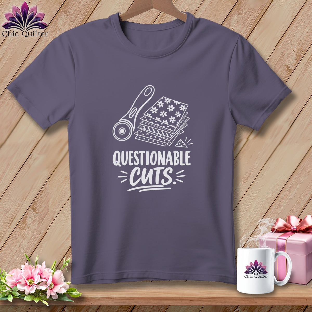 Purple t-shirt with a rotary cutter, fabric stacks, and the text "Questionable Cuts".