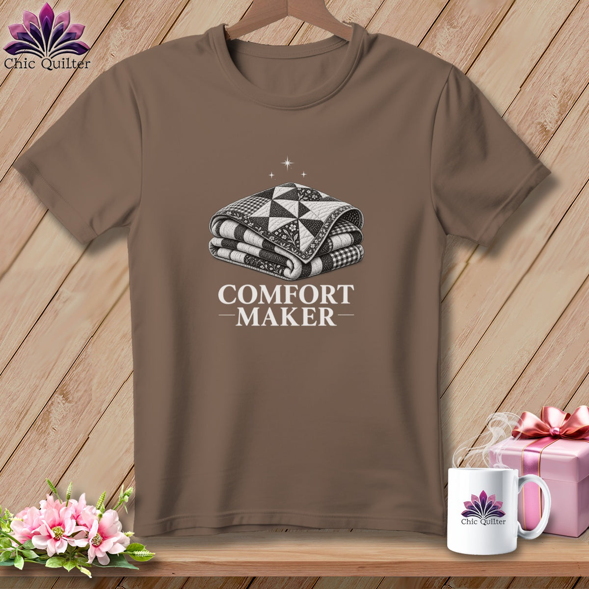 Brown t-shirt with graphic of folded quilt and text "COMFORT MAKER".