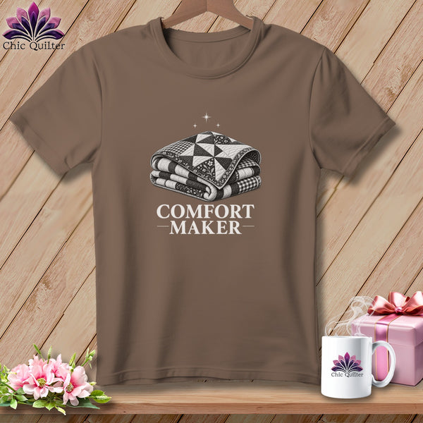 Brown t-shirt with graphic of folded quilt and text "COMFORT MAKER".