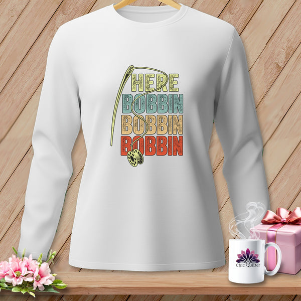 White long sleeve shirt with "HERE BOBBIN BOBBIN BOBBIN" and needle design.