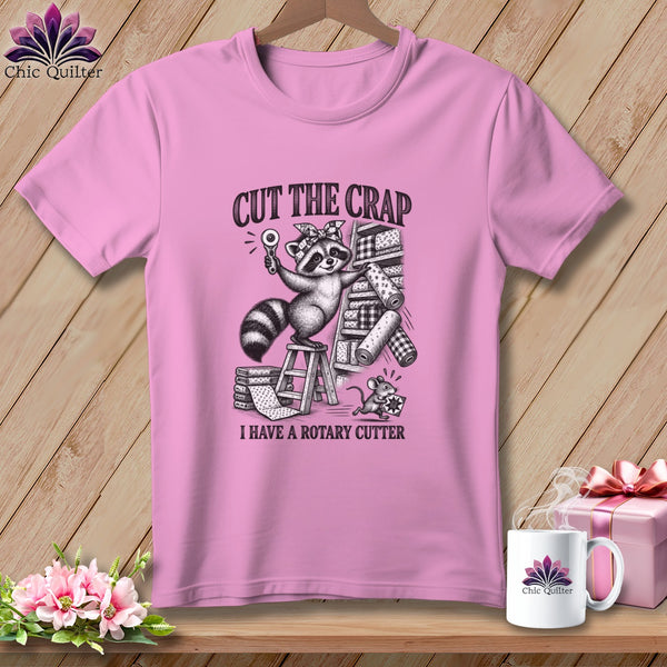 Pink t-shirt with a raccoon holding a rotary cutter and the text "CUT THE CRAP I HAVE A ROTARY CUTTER".