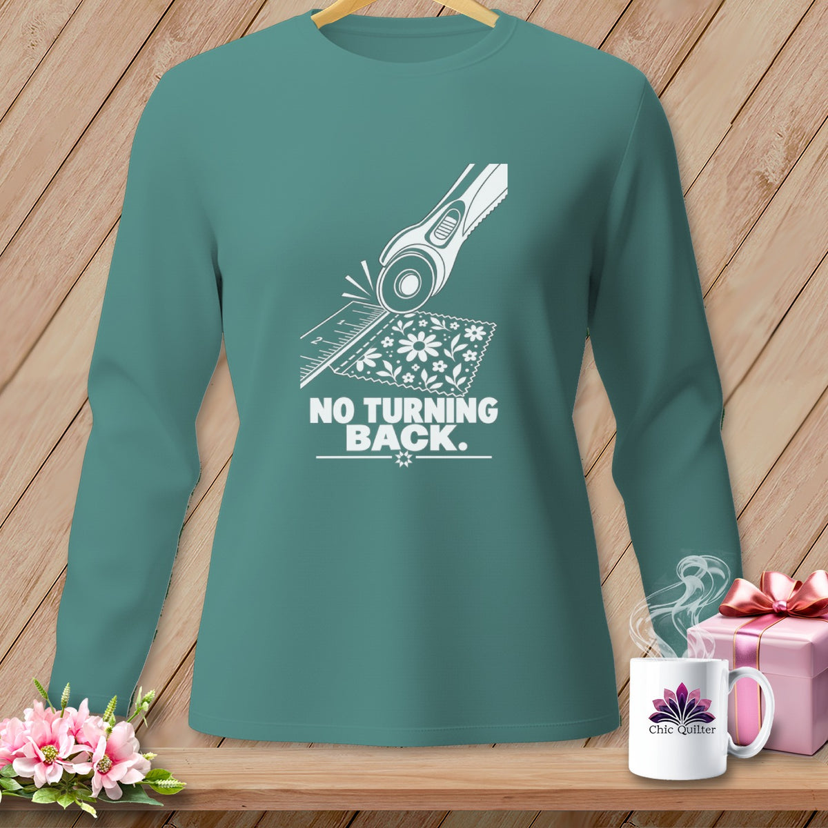 Teal long-sleeve shirt with "NO TURNING BACK." and a rotary cutter graphic.