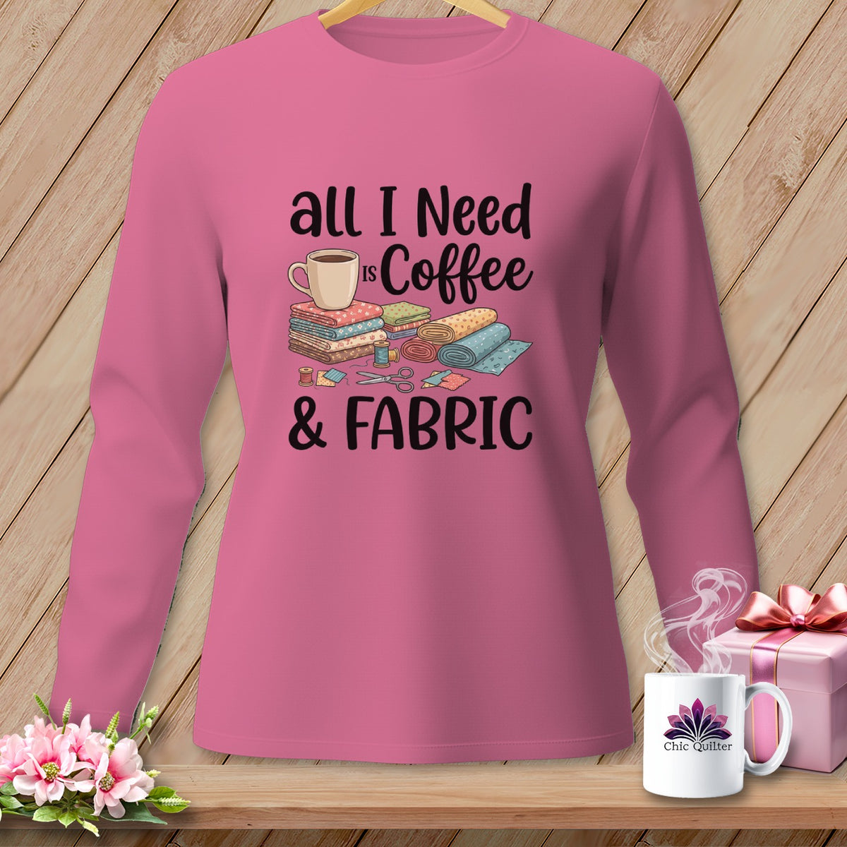 Pink long sleeve shirt with "All I Need Is Coffee & Fabric" text and sewing graphics.