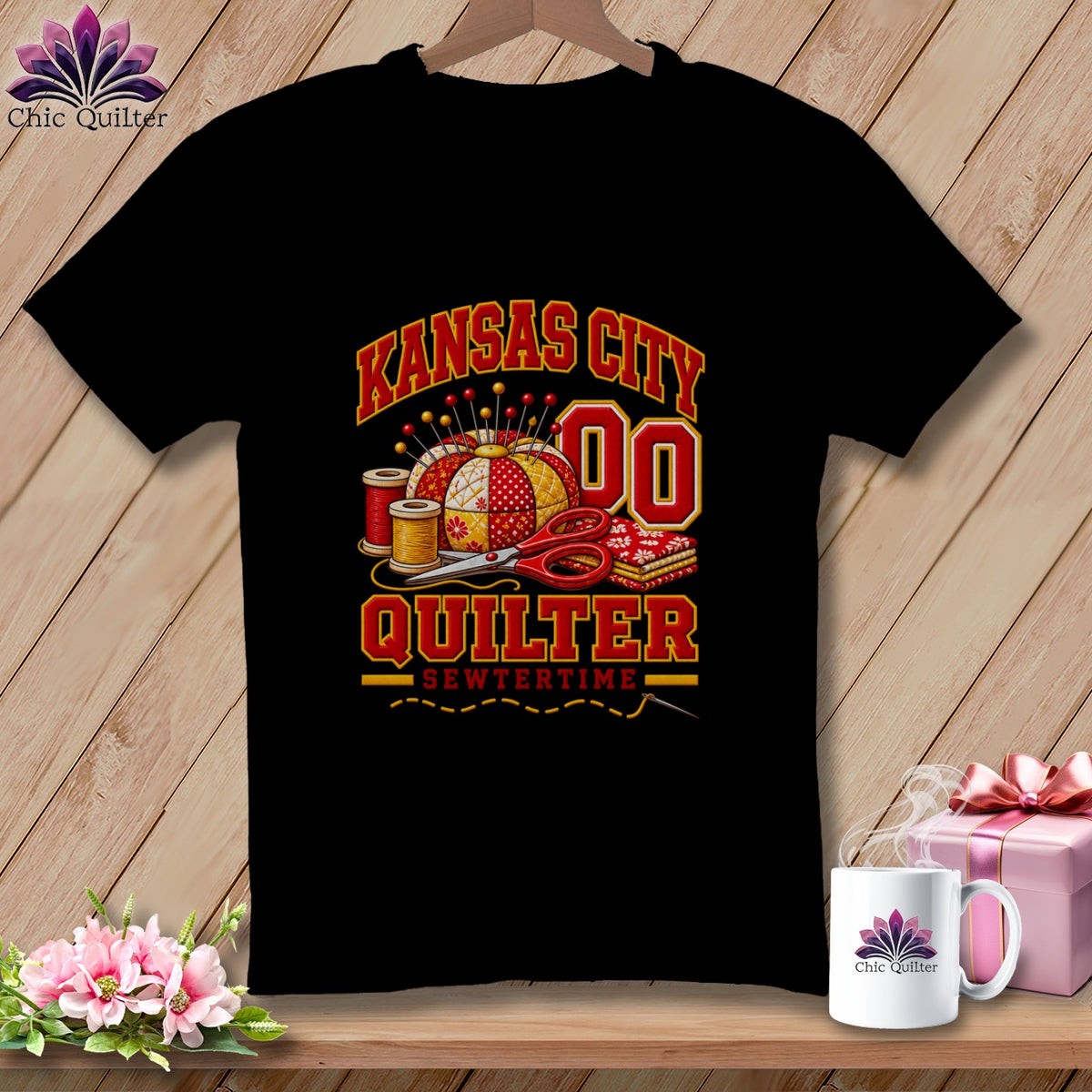 A black t-shirt features Kansas City Quilter graphics, including a pincushion, scissors, and spools of thread.