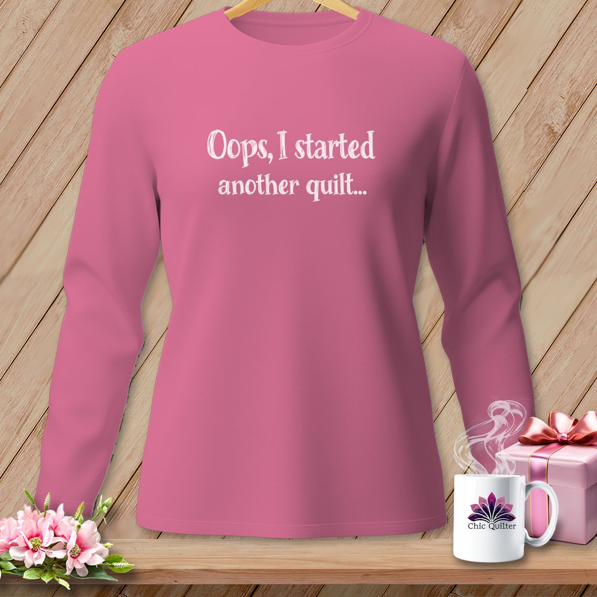 Pink long-sleeve shirt with "Oops, I started another quilt..." text.