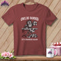 Maroon t-shirt with an owl ironing a quilt, text "OWL BE DAMNED" and "IT'S CROOKED AGAIN".