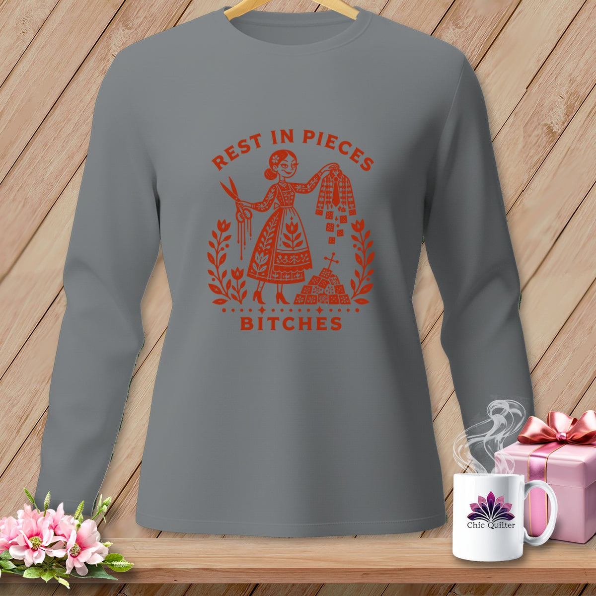 Long sleeve grey shirt with orange graphic reading "REST IN PIECES BITCHES."