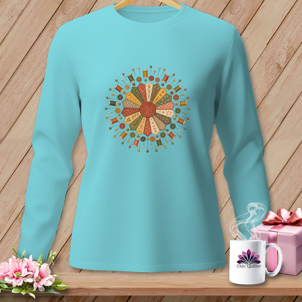 Turquoise long-sleeve shirt with a circular sewing motif featuring spools, buttons, and pins.