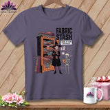 T-shirt graphic of a witch by a fabric stash with text: 