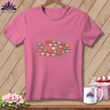 Pink crewneck t-shirt featuring a colorful graphic of stacked wooden spools of thread.