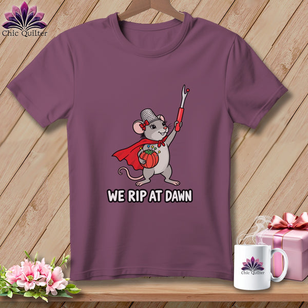 Mauve t-shirt featuring a cartoon mouse holding a seam ripper and tomato pin cushion, with text reading WE RIP AT DAWN.