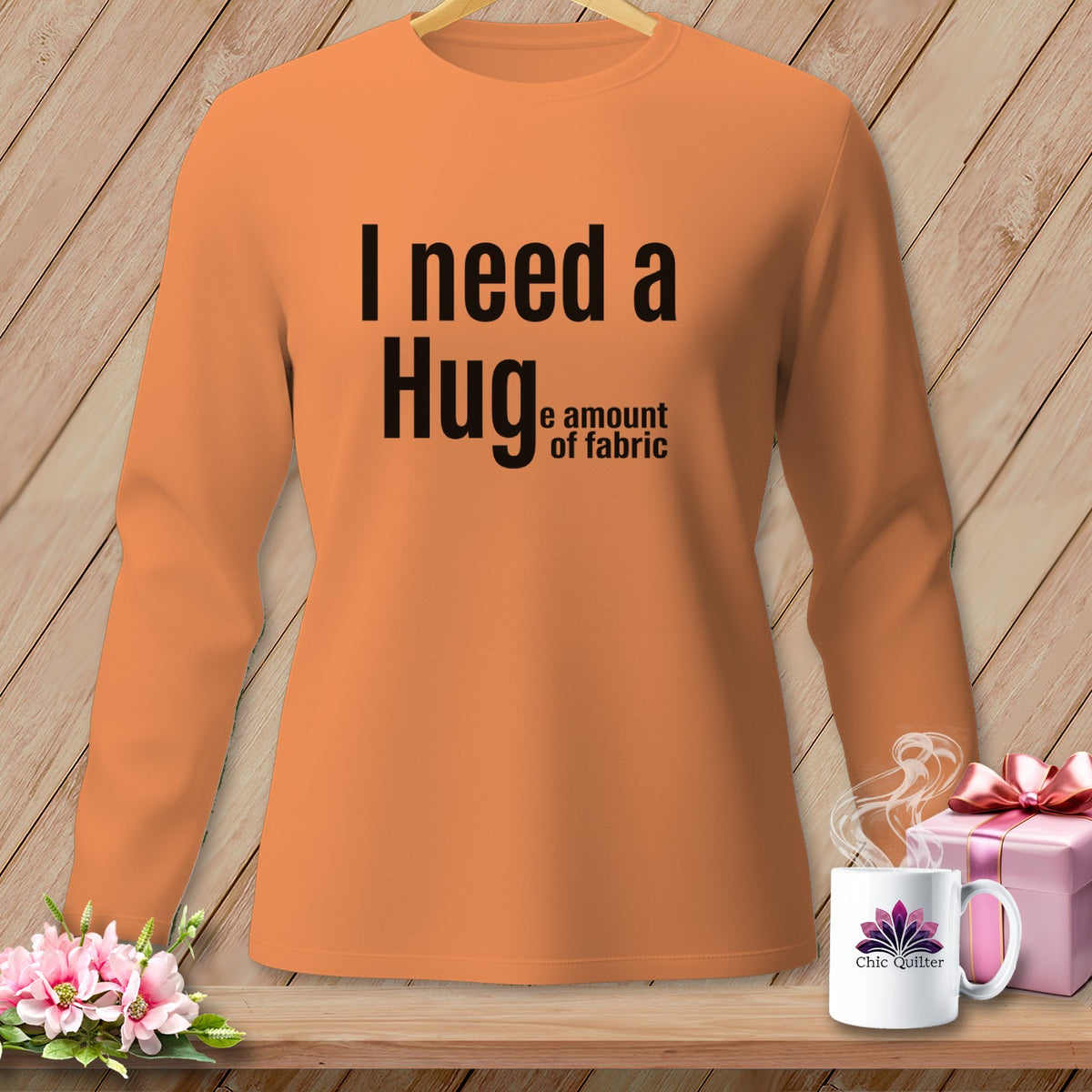 Orange long-sleeve shirt with "I need a Hug, the amount of fabric" text.
