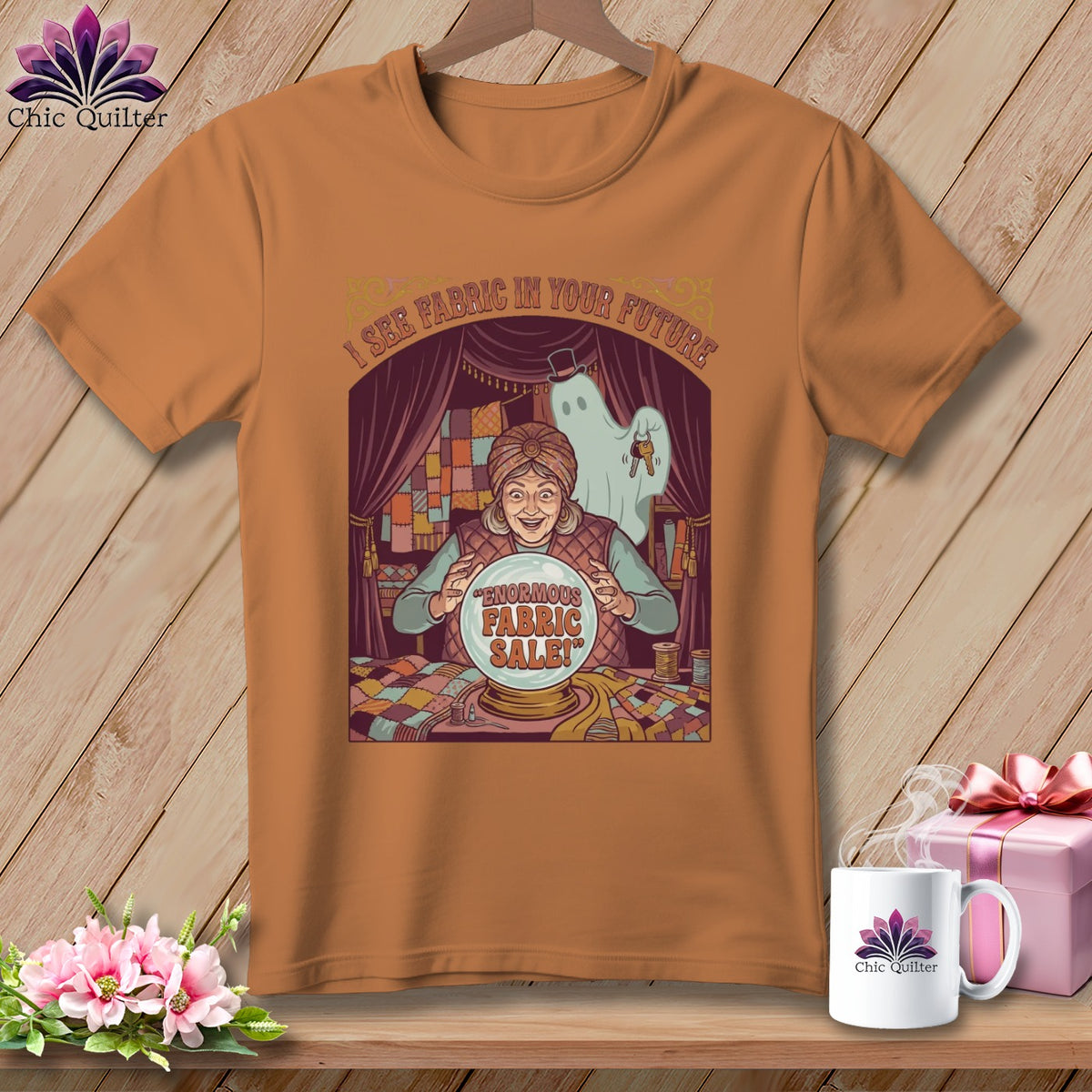 T-shirt graphic with a fortune teller and a ghost predicting "Enormous Fabric Sale!"