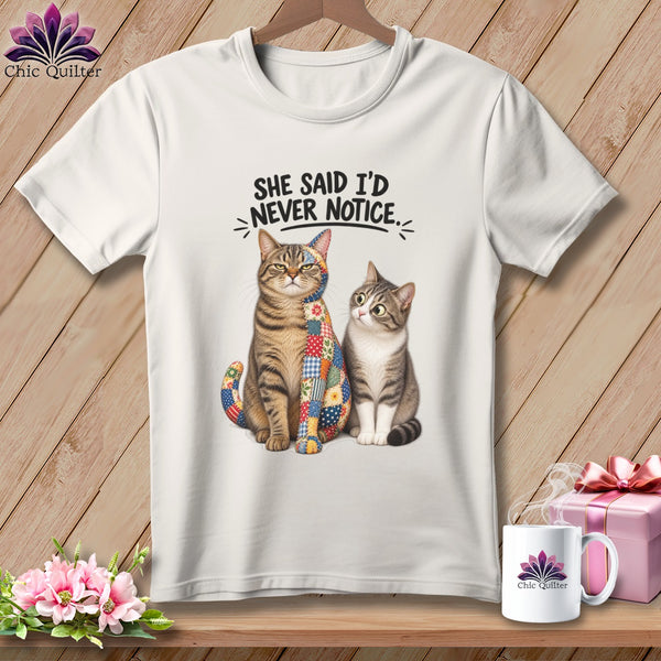 Two cats, one patchwork, sit below text reading "SHE SAID I'D NEVER NOTICE."