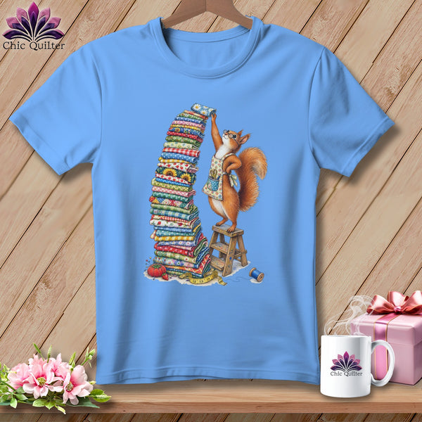 Light blue t-shirt with a squirrel stacking fabric, surrounded by sewing items.