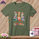 Olive green t-shirt featuring an illustration of three cute, bespectacled birds holding quilts amidst sewing supplies.
