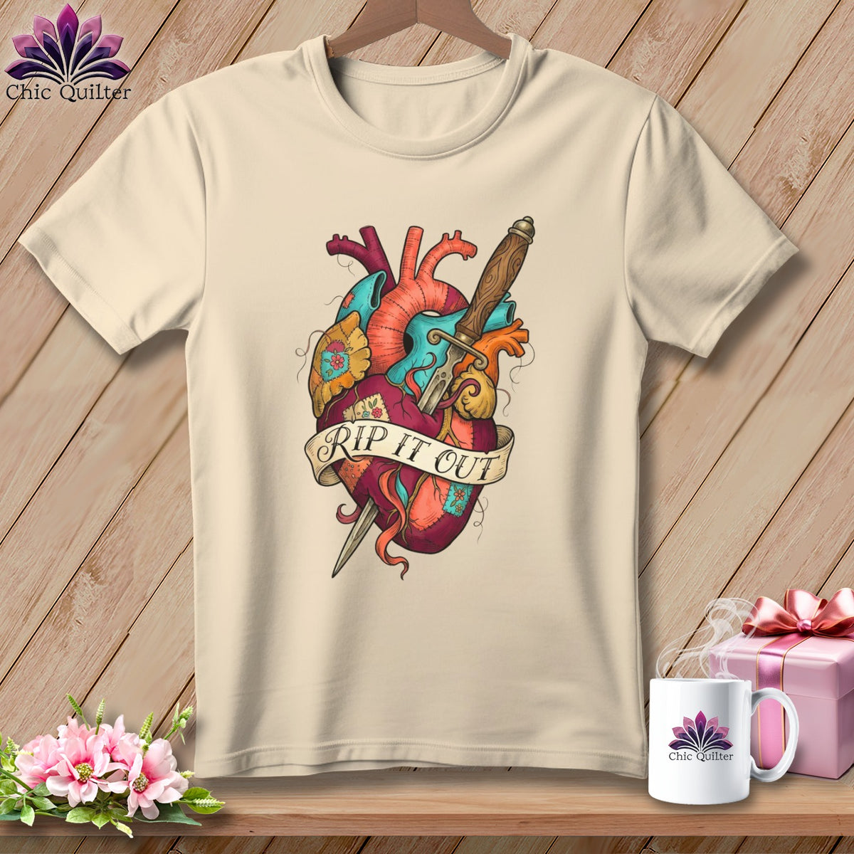 Cream t-shirt with anatomical heart and dagger graphic saying "RIP IT OUT".