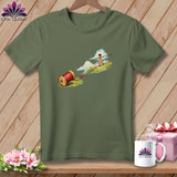 An olive green t-shirt featuring an illustration of a figure tightrope walking on red thread.