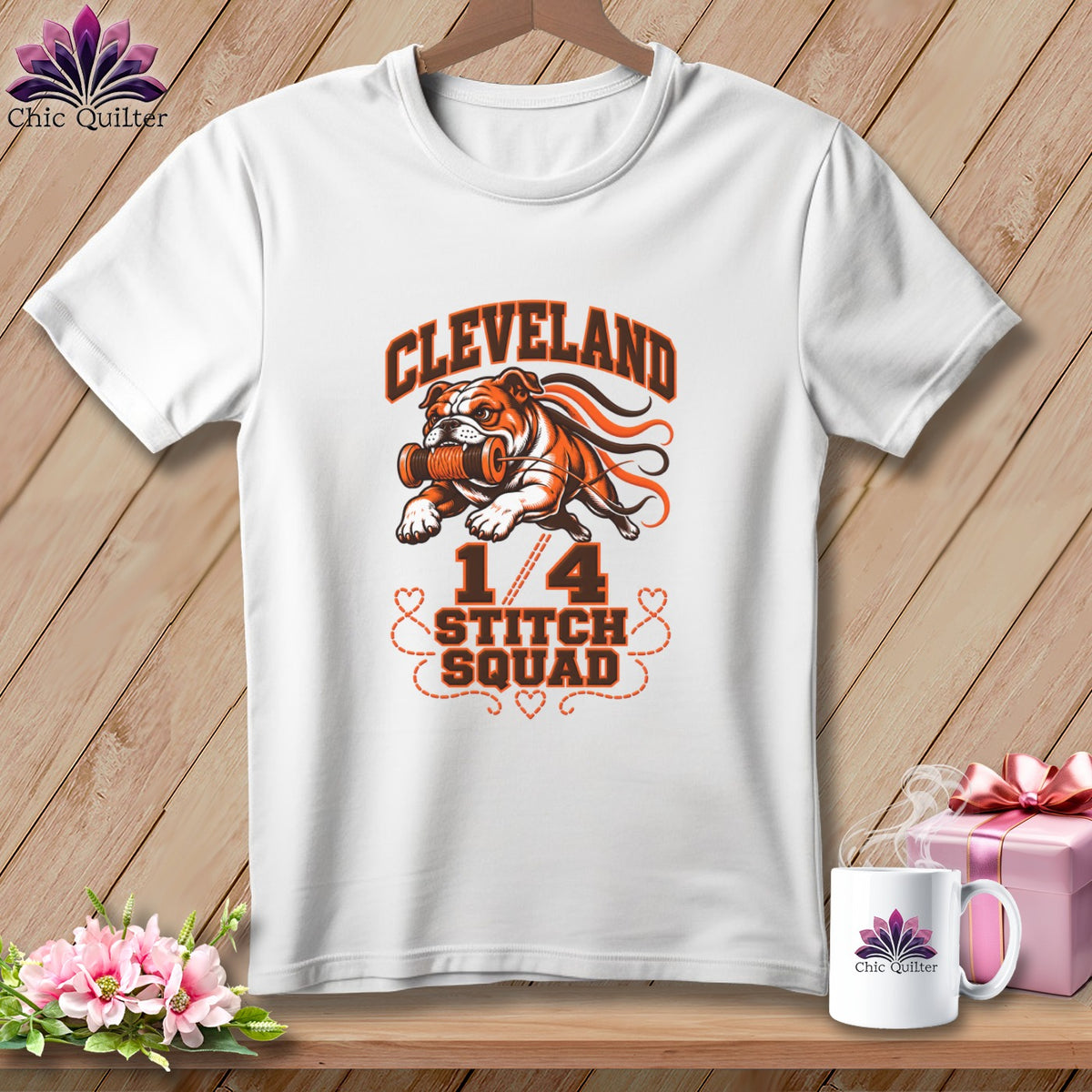 White t-shirt with a graphic of a bulldog holding a spool of thread and the text Cleveland 1/4 Stitch Squad.