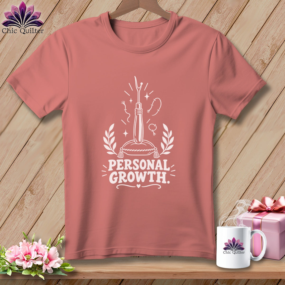 Rose-colored t-shirt with "Personal Growth" and sewing graphics.