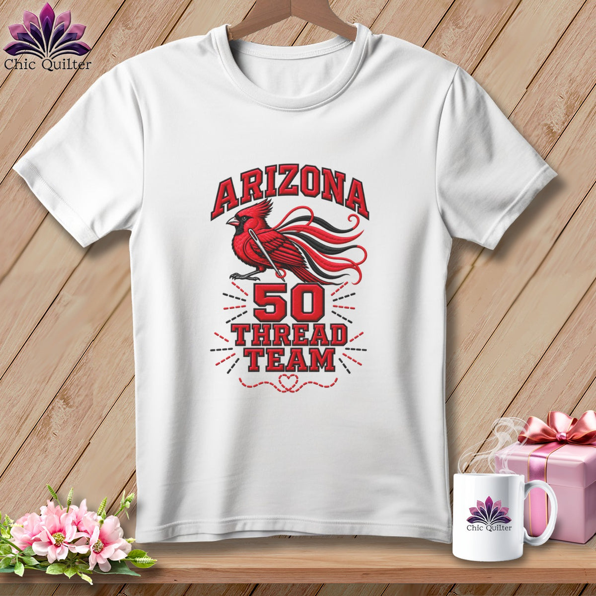 White t-shirt featuring a red cardinal graphic and text reading Arizona 50 Thread Team hanging on a wooden background.