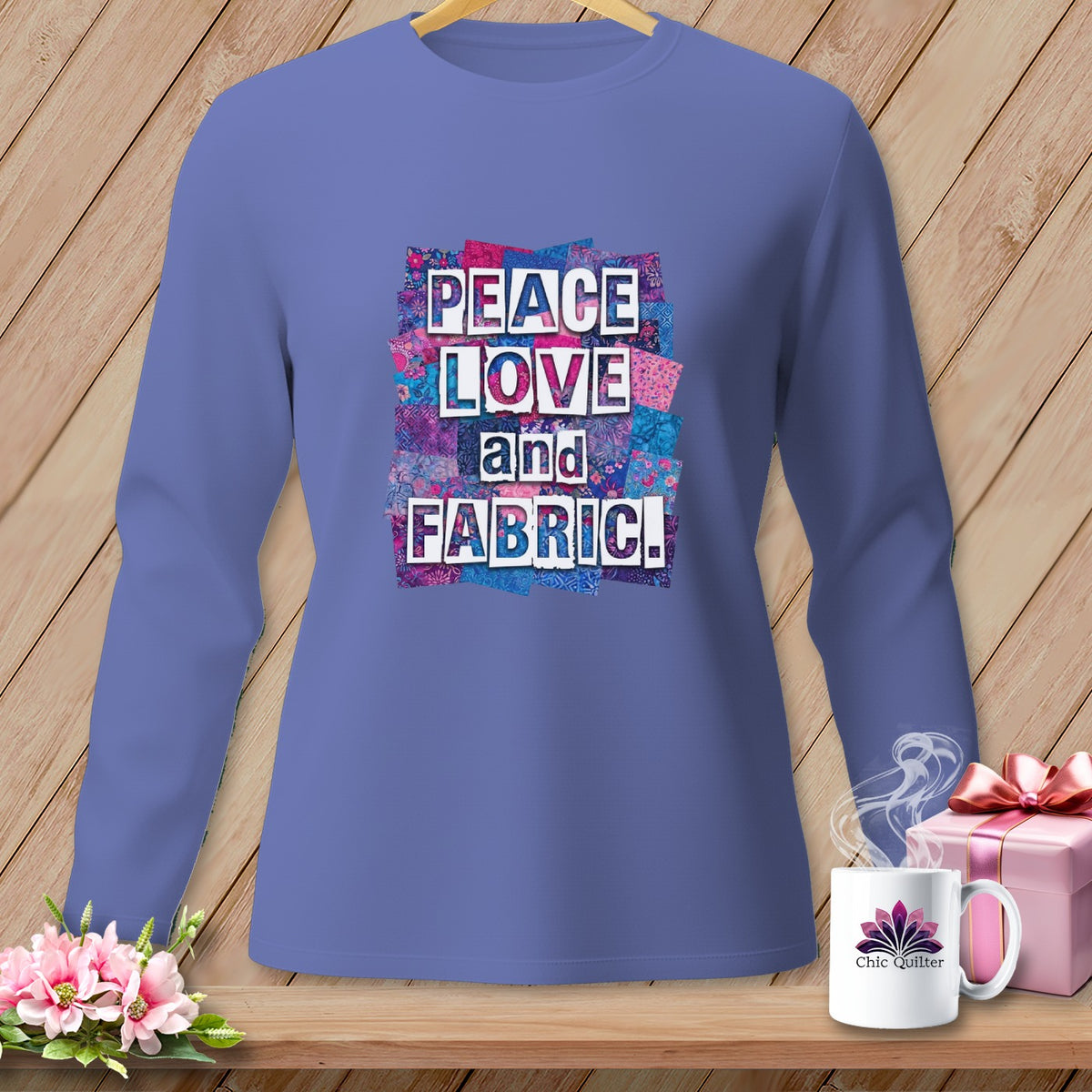 Long-sleeved shirt with "Peace Love and Fabric!" text on a patchwork background.