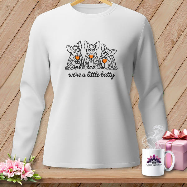 White long-sleeve shirt with three cartoon bats drinking and the text "we're a little batty".