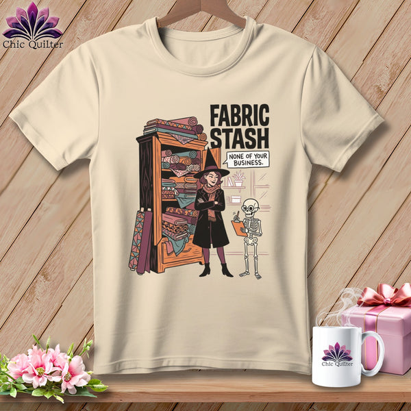 T-shirt graphic: Witch with fabric stash, skeleton, text "Fabric Stash None of Your Business."