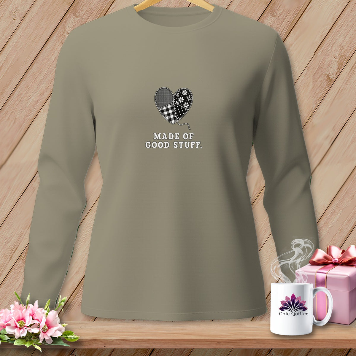 Tan long-sleeved shirt with patched heart graphic and text "MADE OF GOOD STUFF."