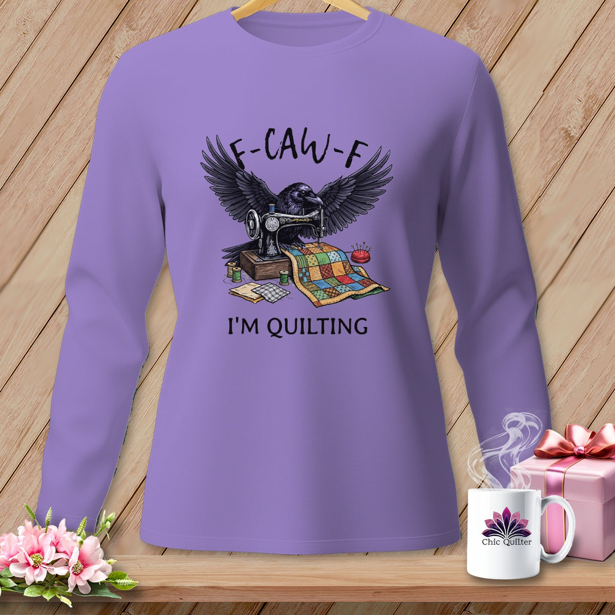 Purple long-sleeve shirt with a raven, sewing machine, and quilt graphic that says "F-CAW-F I'M QUILTING".