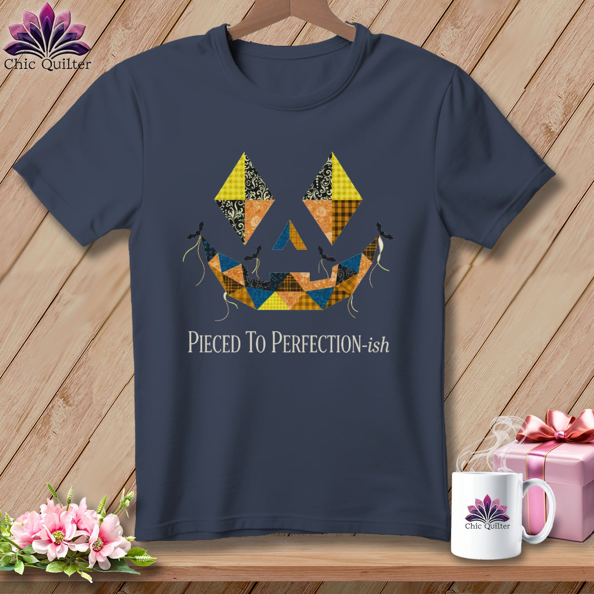 Navy t-shirt with a patchwork jack-o'-lantern face and "Pieced To Perfection-ish" text.